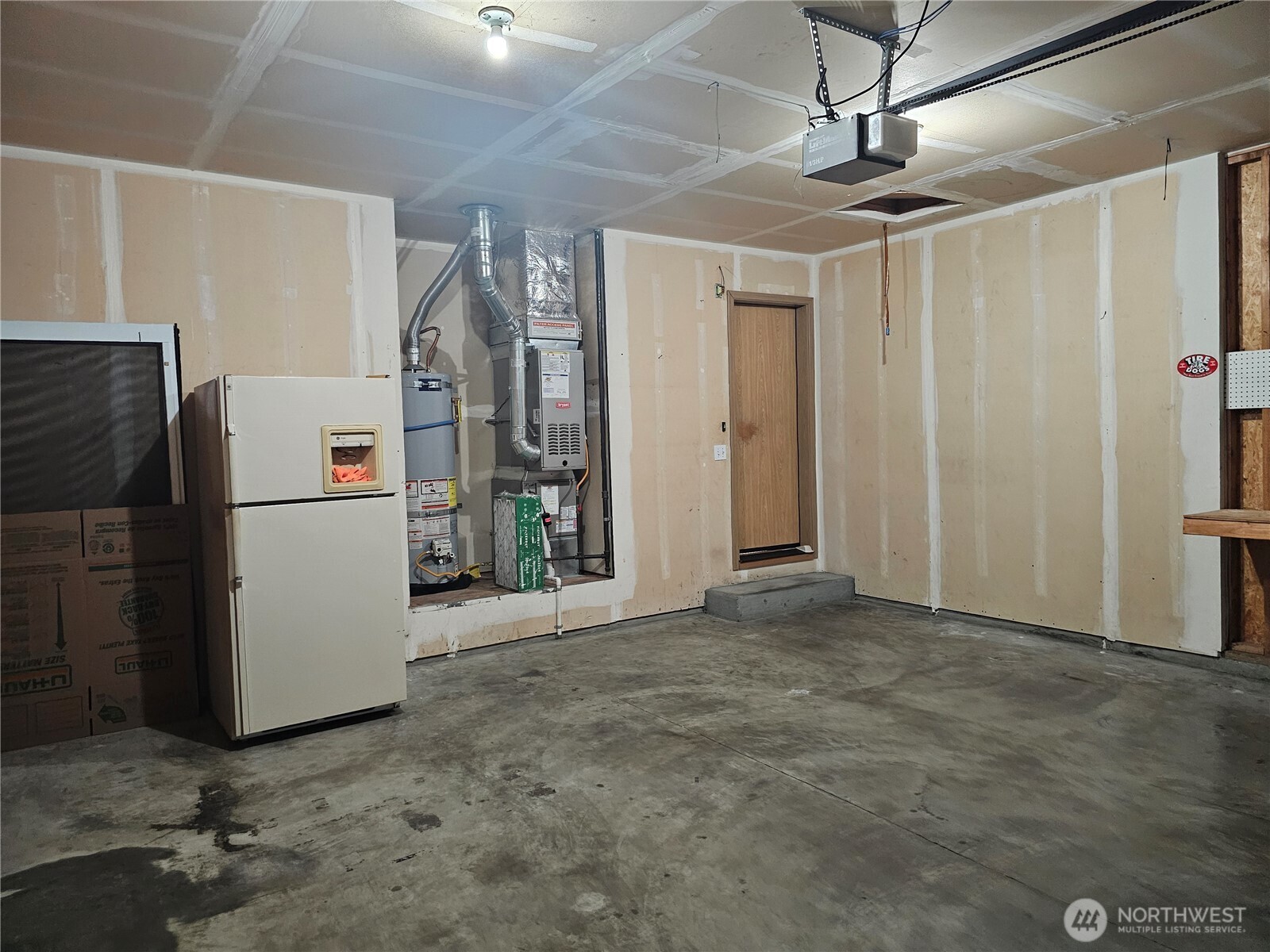 9814 Greenleaf Loop Southeast Yelm, WA 98597 - Photo 33 of 33 a view of a refrigerator in kitchen and an empty room