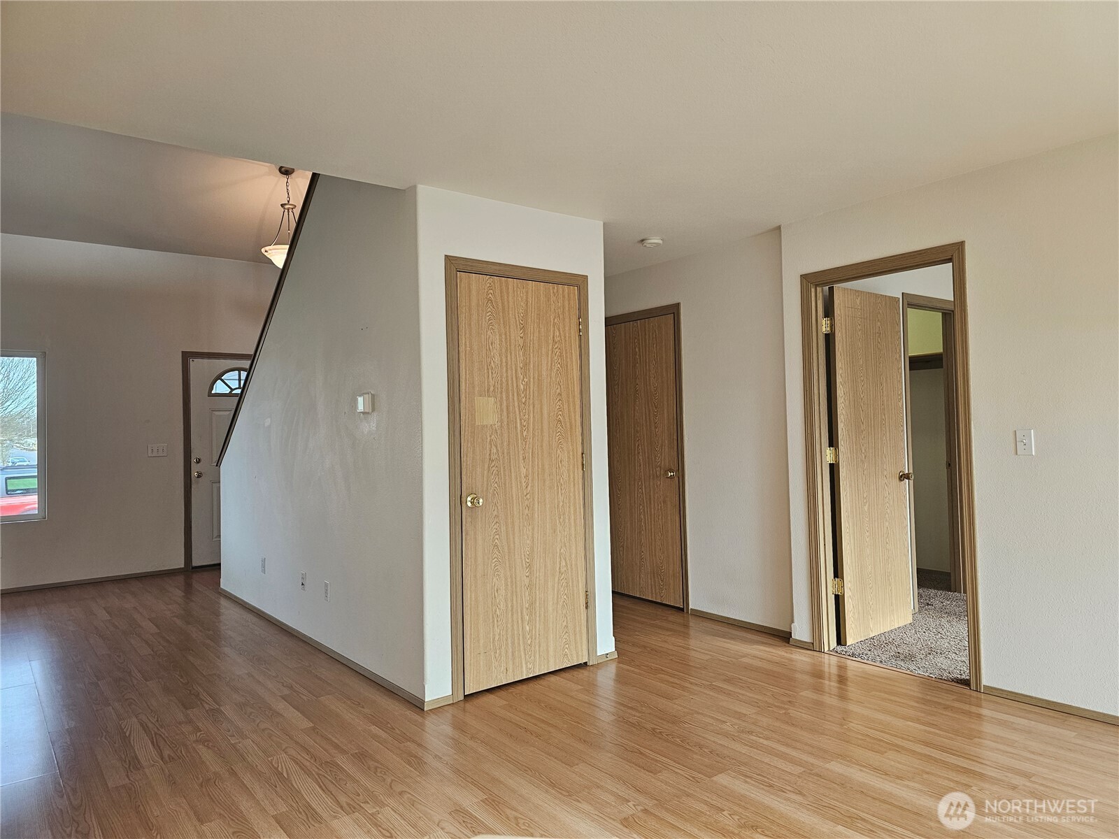 9814 Greenleaf Loop Southeast Yelm, WA 98597 - Photo 8 of 33 a view of a livingroom with wooden floor and staircase