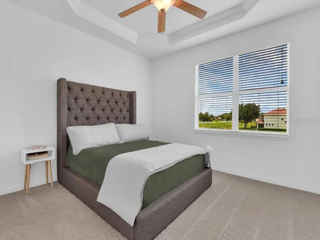 a bedroom with a bed and a wall painting