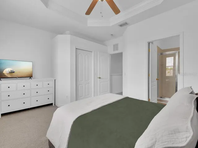 a bedroom with a bed and a dresser in it