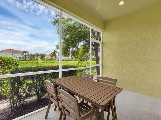 a view of a balcony with table and chairs