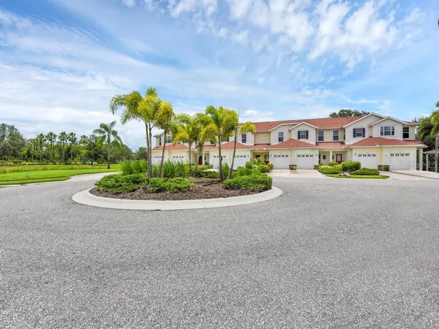 a front view of a house with a yard and outdoor seating