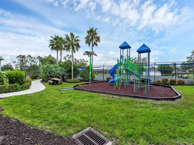 a view of a house with a backyard and a patio