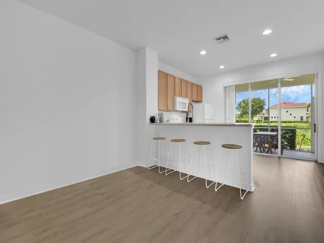 a kitchen with a sink cabinets and wooden floor