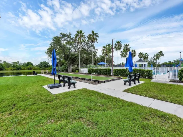 a view of a park with bench and trees