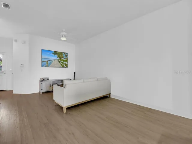 a living room with couches and painting on the wall