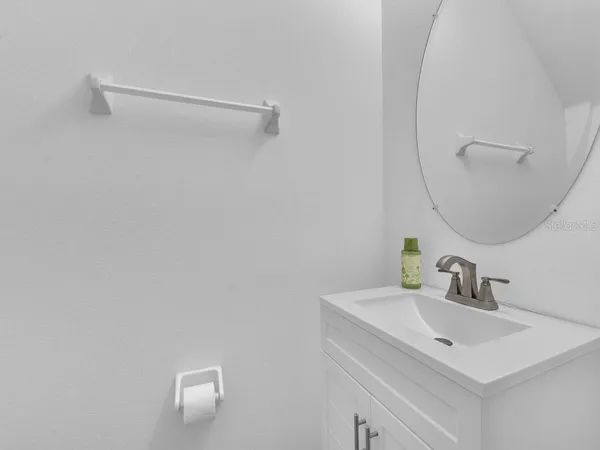 a bathroom with a sink vanity and a mirror