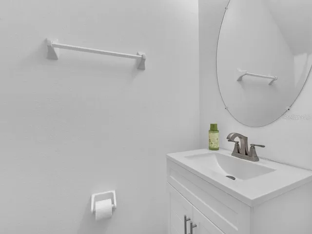 a bathroom with a sink vanity and a mirror