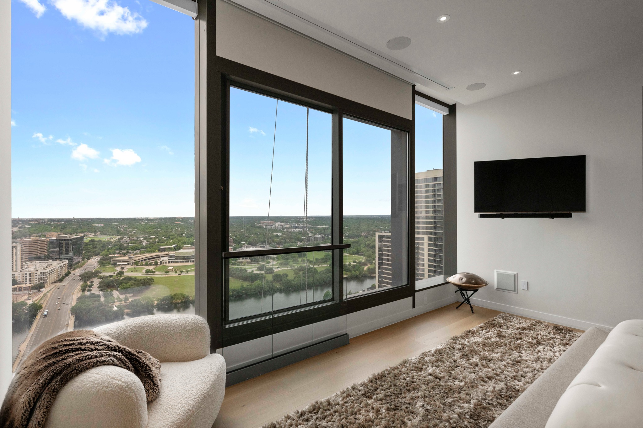210 Lavaca Street, Unit 2706 Austin, TX 78701 - Photo 16 of 32 Floor-to-ceiling windows with dark framing overlook a cityscape and water feature