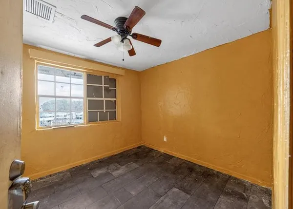 a view of room with window and ceiling fan