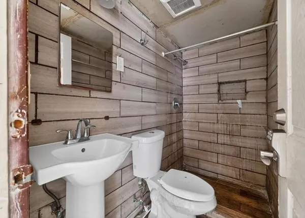 a bathroom with a toilet and shower
