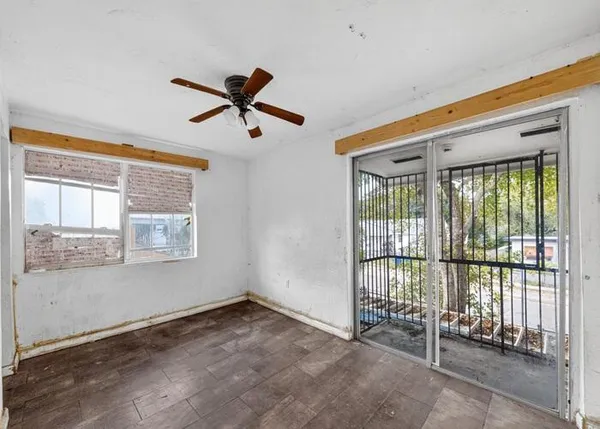 a view of a livingroom with a ceiling fan and window