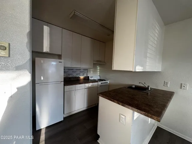 a kitchen with a refrigerator and a sink