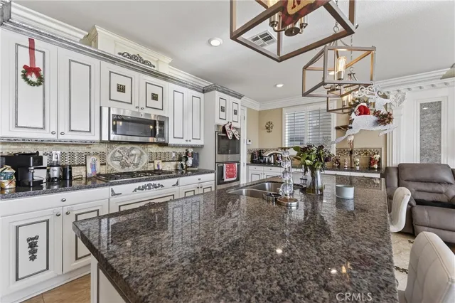 a kitchen with stainless steel appliances granite countertop a stove and cabinets