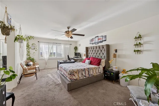 a bedroom with a bed furniture and a chandelier