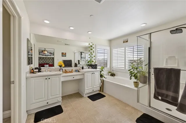 a large white kitchen with a white countertops a fireplace and a dining table