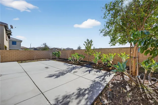 a view of a dry yard with wooden fence
