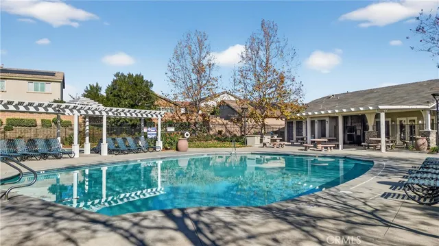 a view of a house with backyard and sitting area