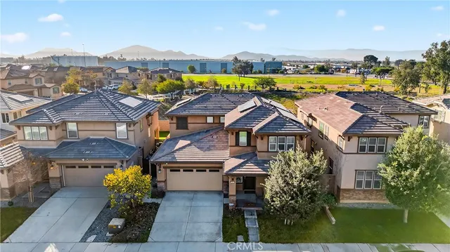 an aerial view of residential houses with yard and swimming pool