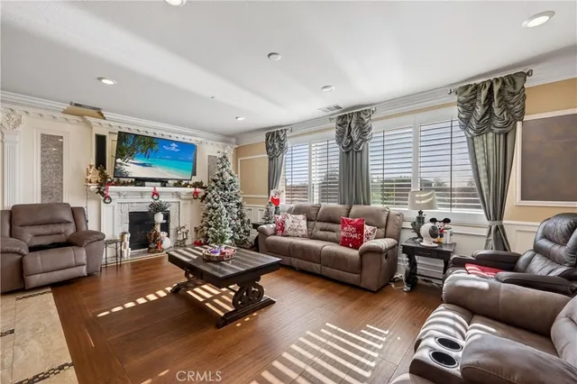 a living room with furniture fireplace and a large window