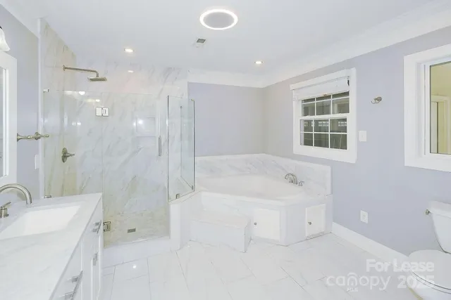a spacious bathroom with a tub sink shower and mirror
