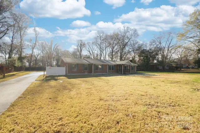 a house view with swimming pool in front of it