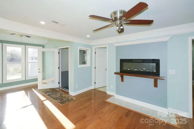 a bedroom with a bed and a ceiling fan