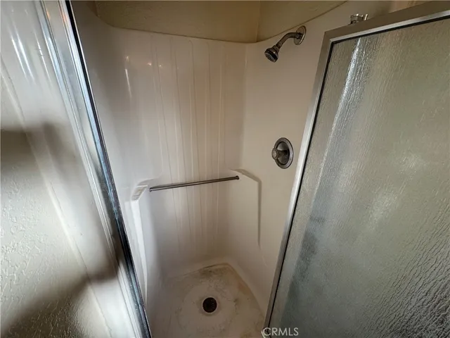 a view of a room with wooden floor and a window