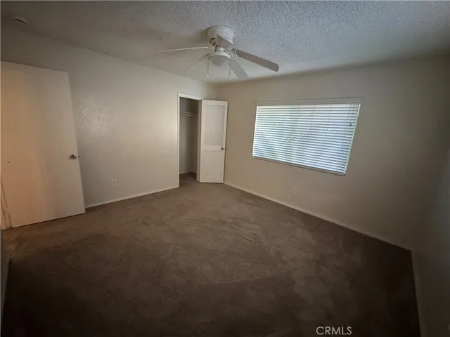an empty room with windows and closet