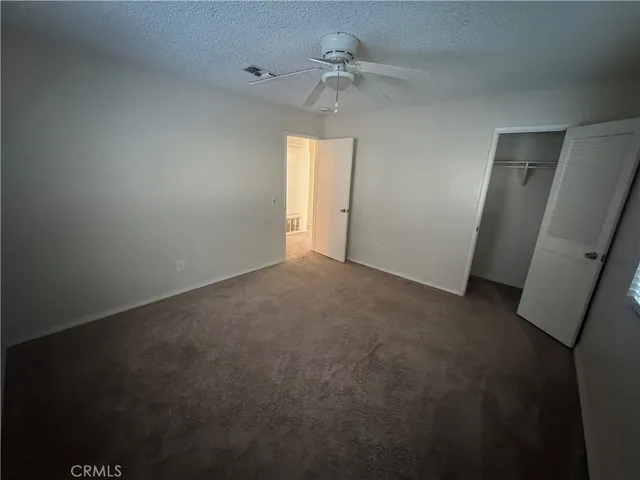 an empty room with windows and entrance