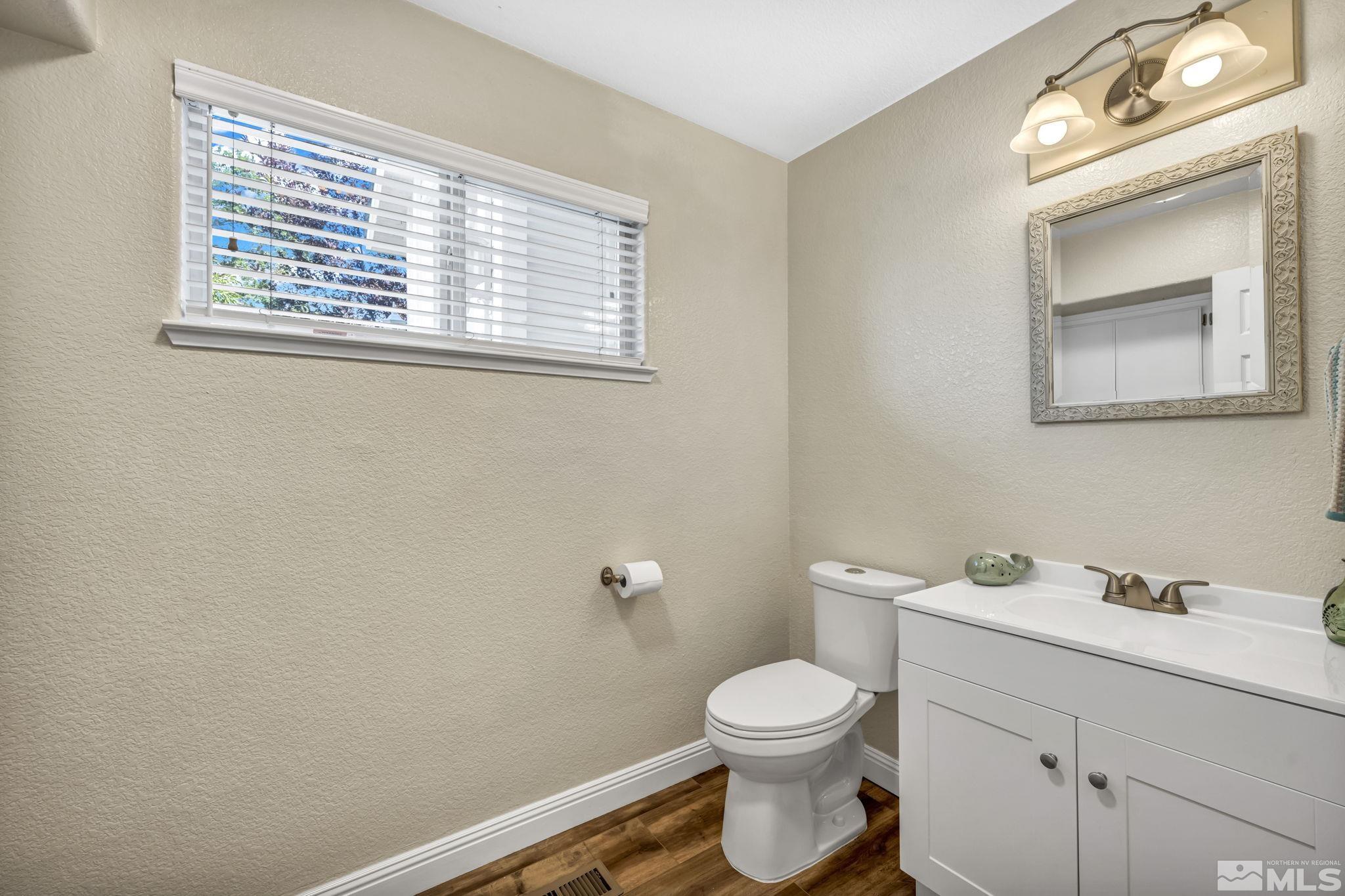 7491 Wheeldale Circle Reno, NV 89511 - Photo 15 of 33 a bathroom with a toilet sink vanity and mirror
