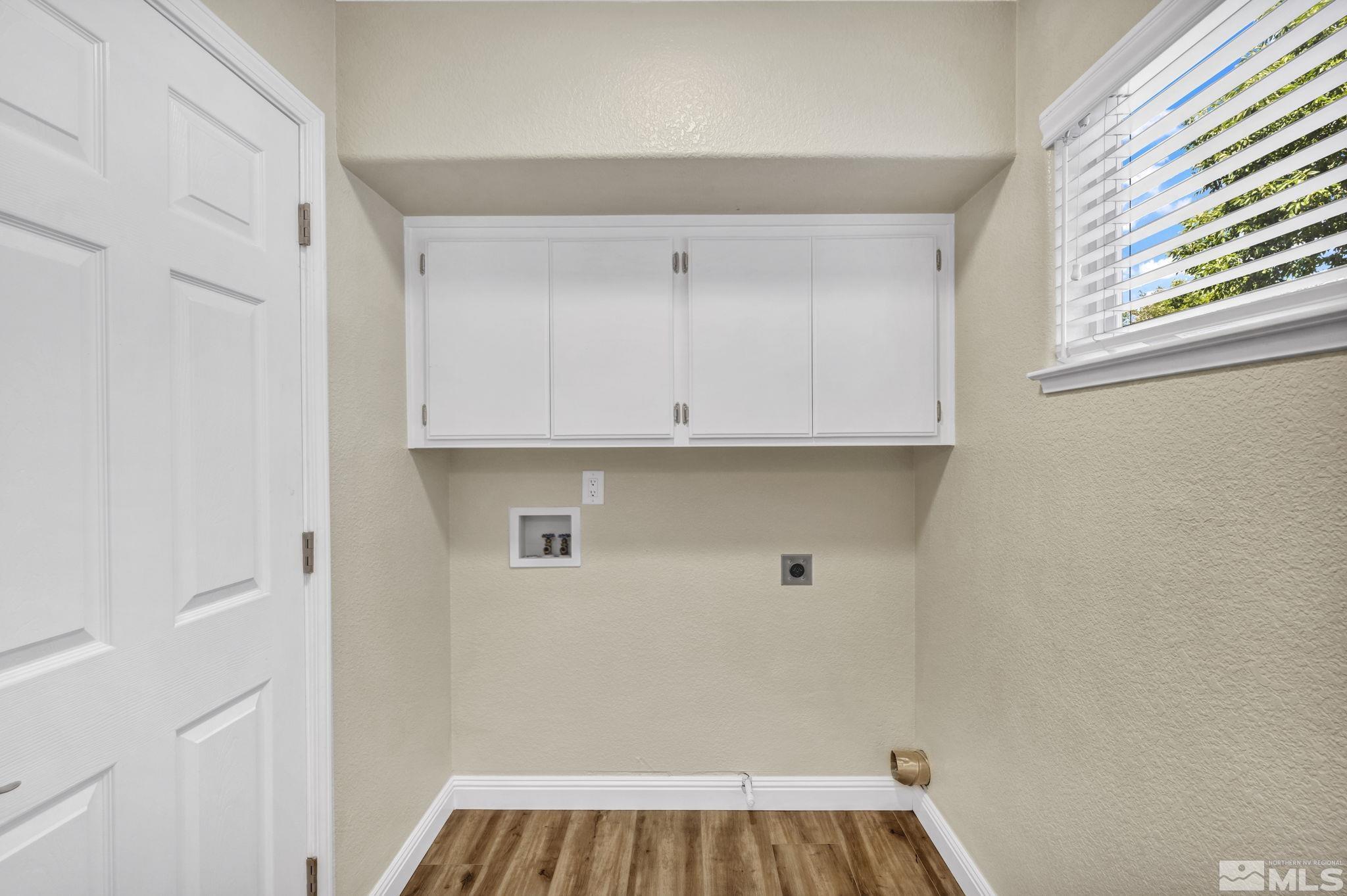 7491 Wheeldale Circle Reno, NV 89511 - Photo 16 of 33 a view of a kitchen with white cabinets and a window