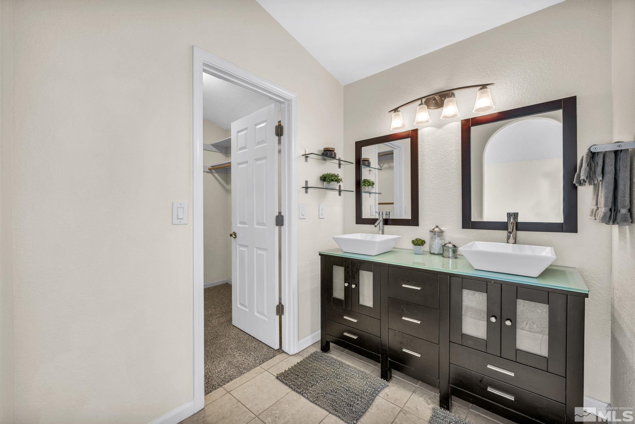 7491 Wheeldale Circle Reno, NV 89511 - Photo 20 of 33 a bathroom with a double vanity sink and mirror