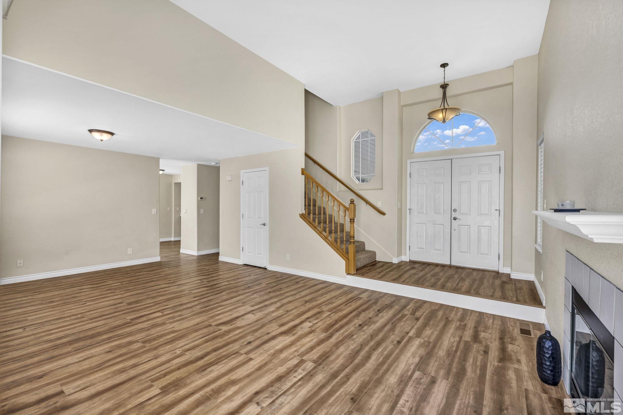 7491 Wheeldale Circle Reno, NV 89511 - Photo 3 of 33 a view of an empty room with window and wooden floor