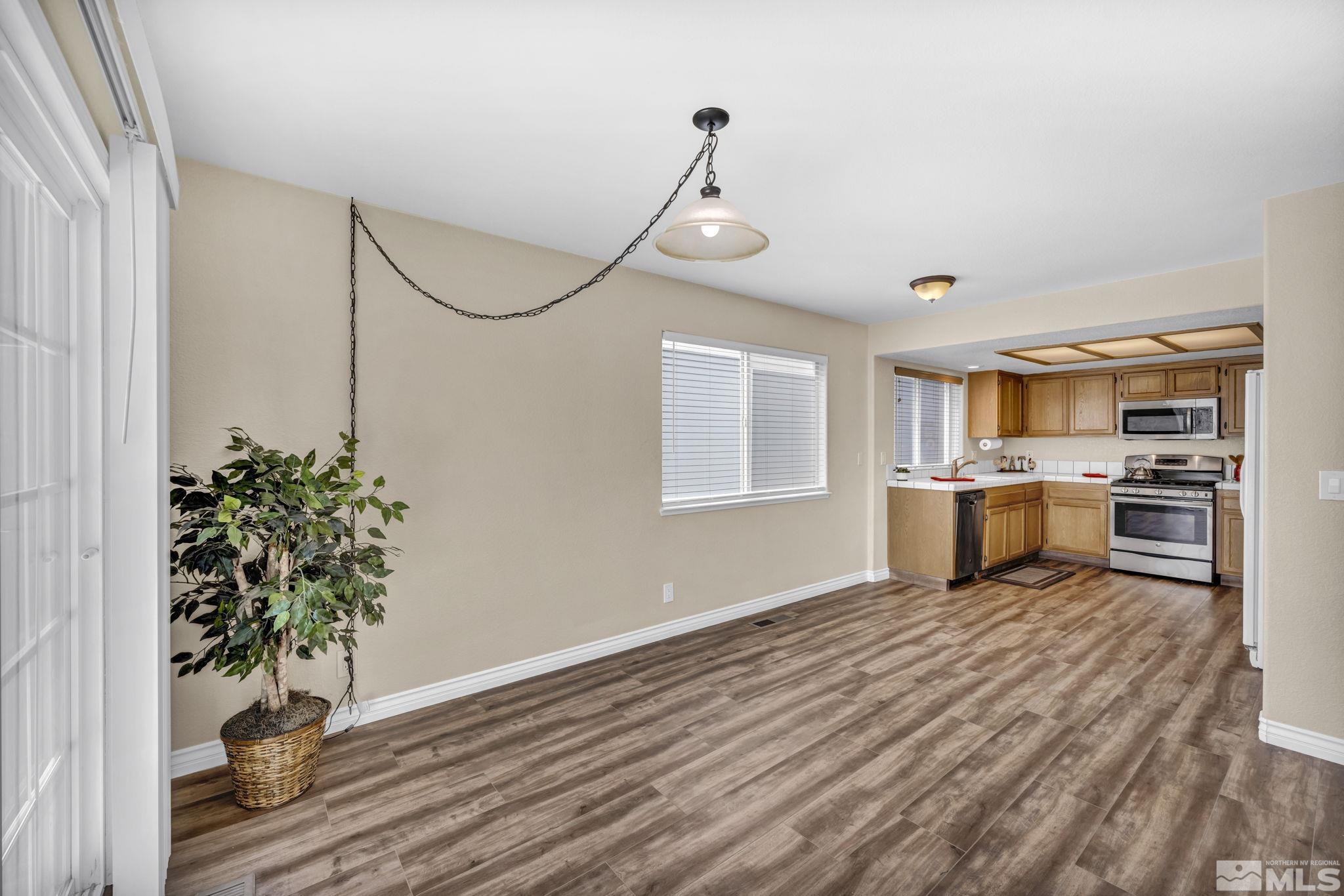 7491 Wheeldale Circle Reno, NV 89511 - Photo 10 of 33 a view of a kitchen with wooden floor and a window