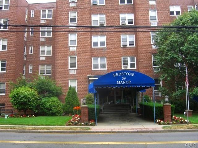 39 Glenbrook Road, Unit 2J Stamford, CT 06902 - Photo 1 of 1 a view of a building with a garden
