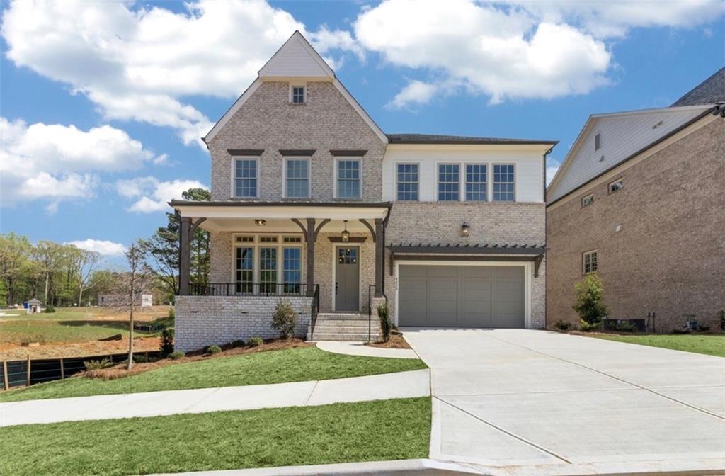 3941 Enclave Way Tucker, GA 30084 - Photo 1 of 1 a front view of a house with a yard and garage