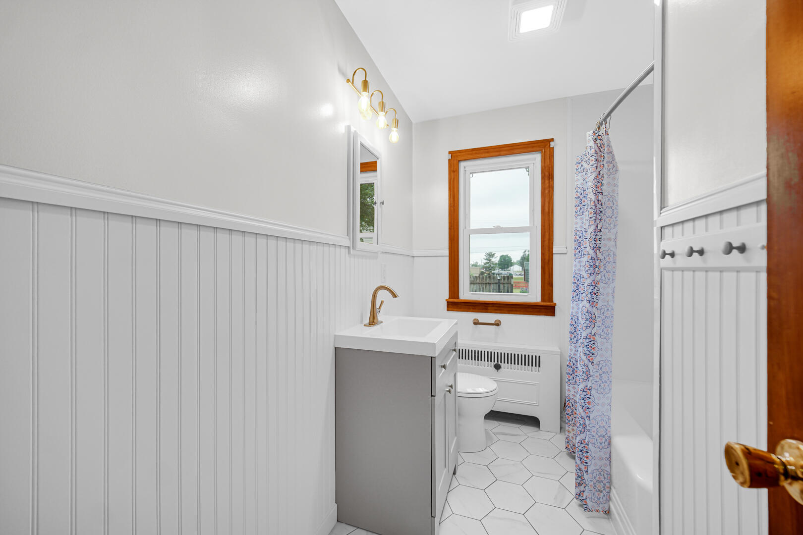 602 Ohio Street Walkerton, IN 46574 - Photo 11 of 31 a bathroom with a sink a toilet and a window