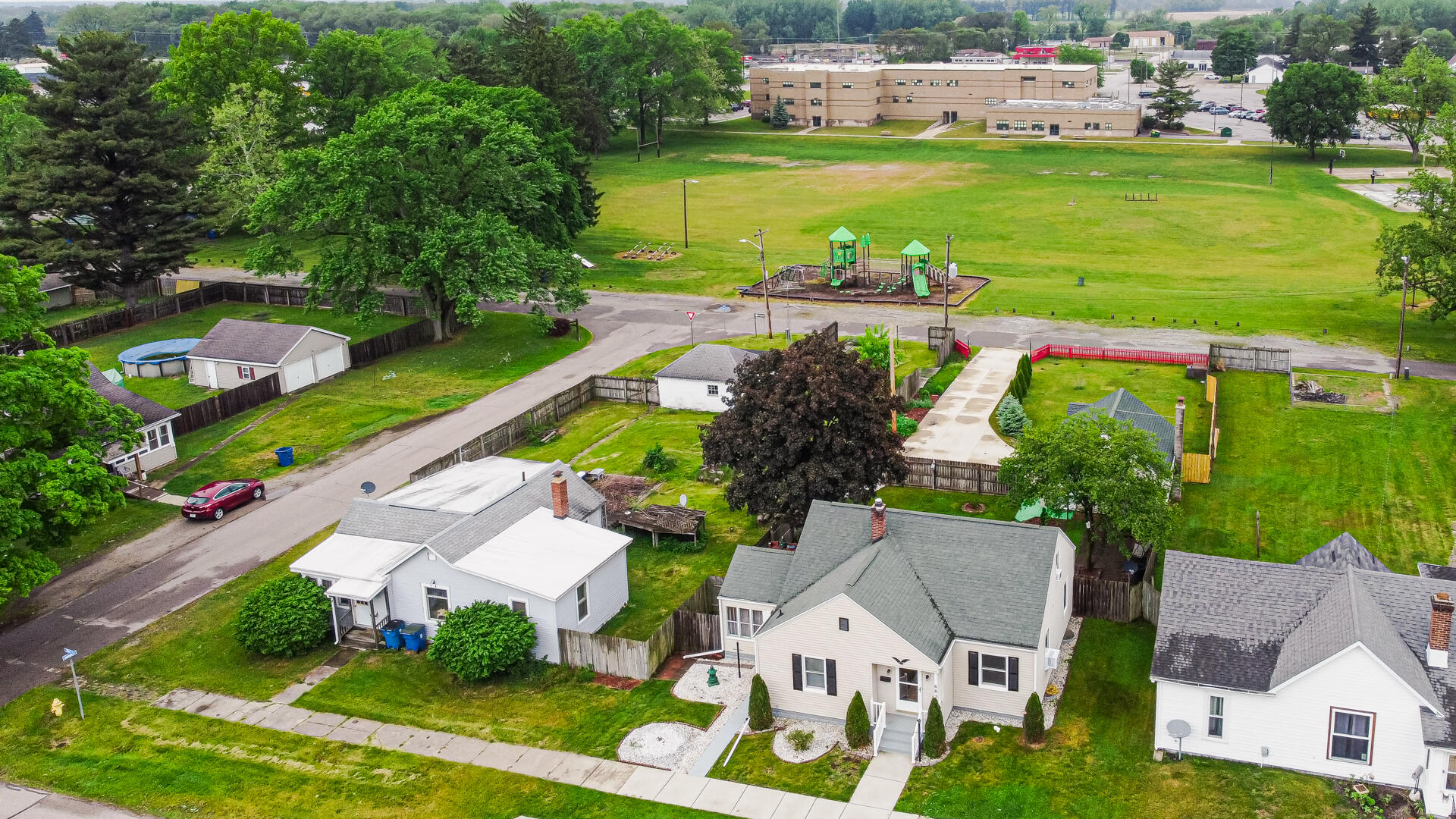 602 Ohio Street Walkerton, IN 46574 - Photo 2 of 31 an aerial view of a house with outdoor space swimming pool patio and lake view