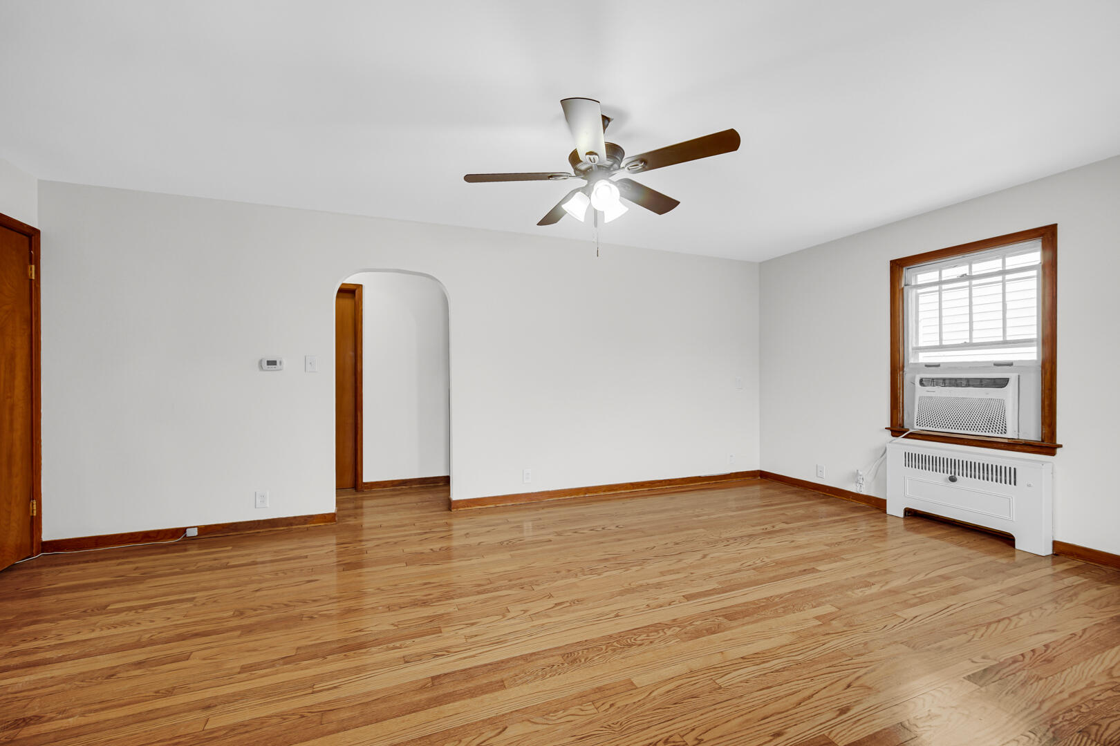 602 Ohio Street Walkerton, IN 46574 - Photo 4 of 31 a view of an empty room with wooden floor and a window