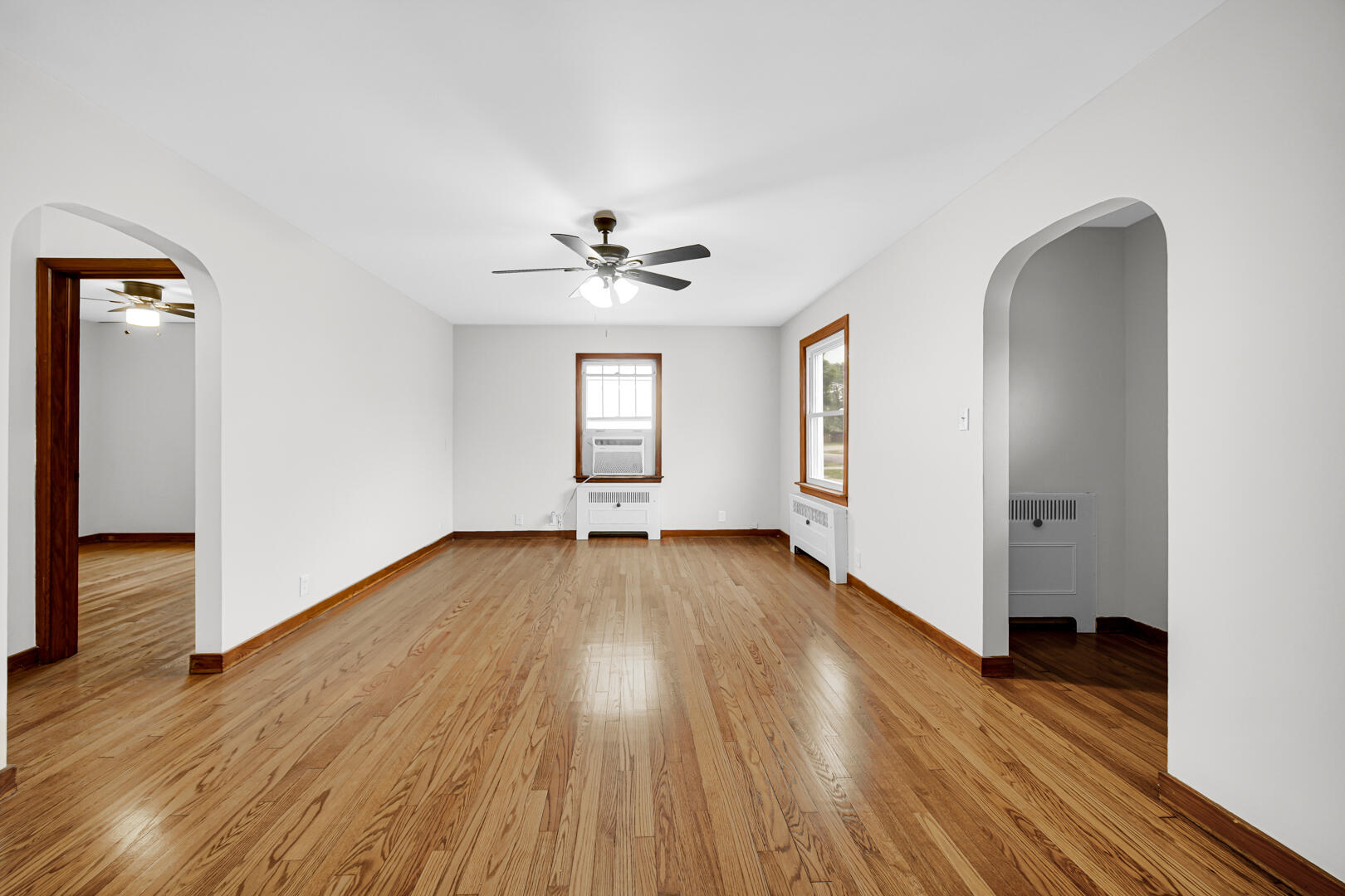 602 Ohio Street Walkerton, IN 46574 - Photo 5 of 31 an empty room with wooden floor and windows