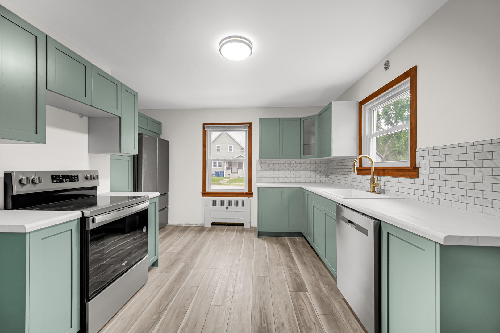 602 Ohio Street Walkerton, IN 46574 - Photo 6 of 31 a kitchen with granite countertop a sink cabinets stainless steel appliances and a window
