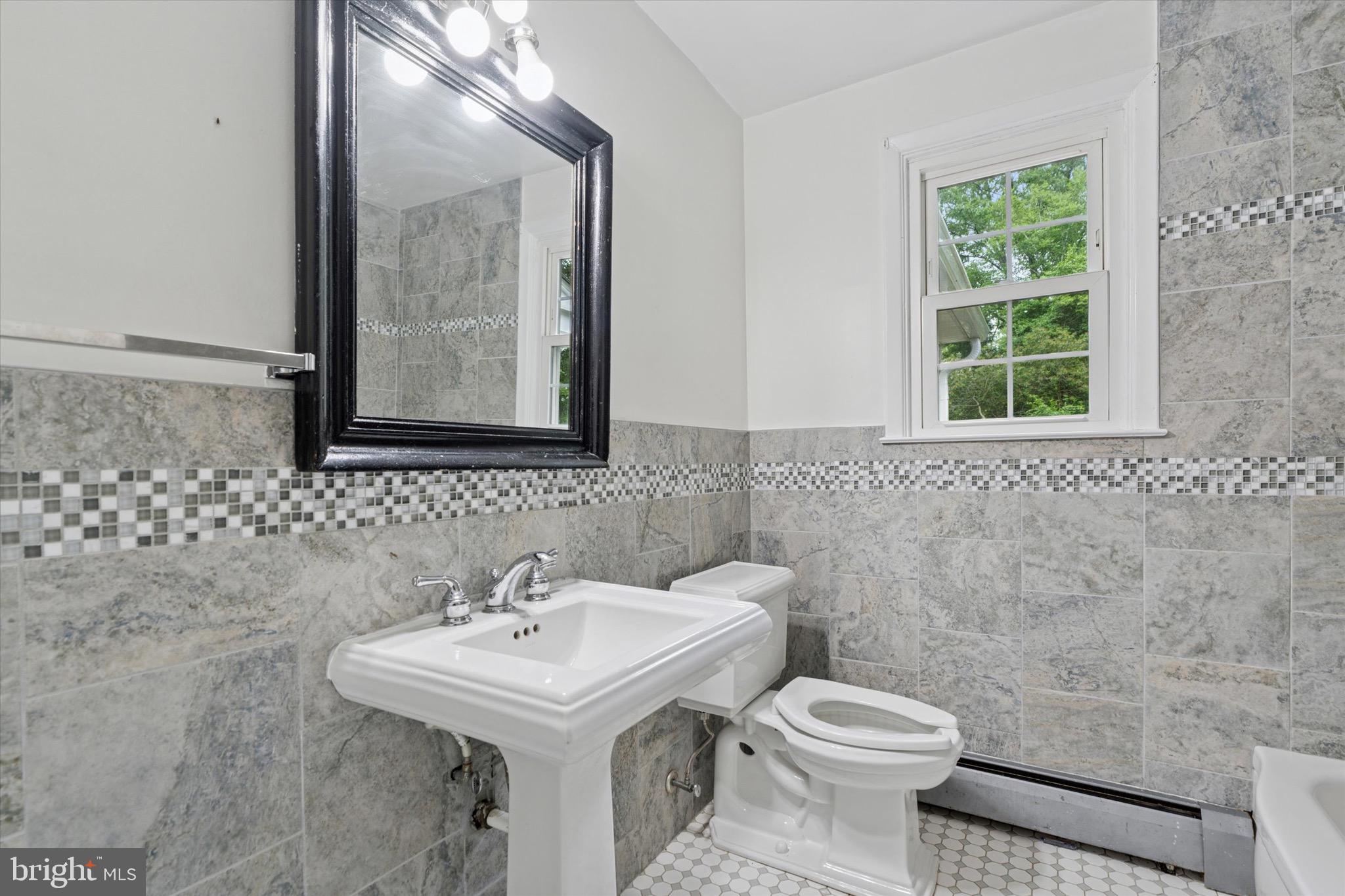 414 Darlington Road Media, PA 19063 - Photo 22 of 51 a bathroom with a sink a toilet and a mirror