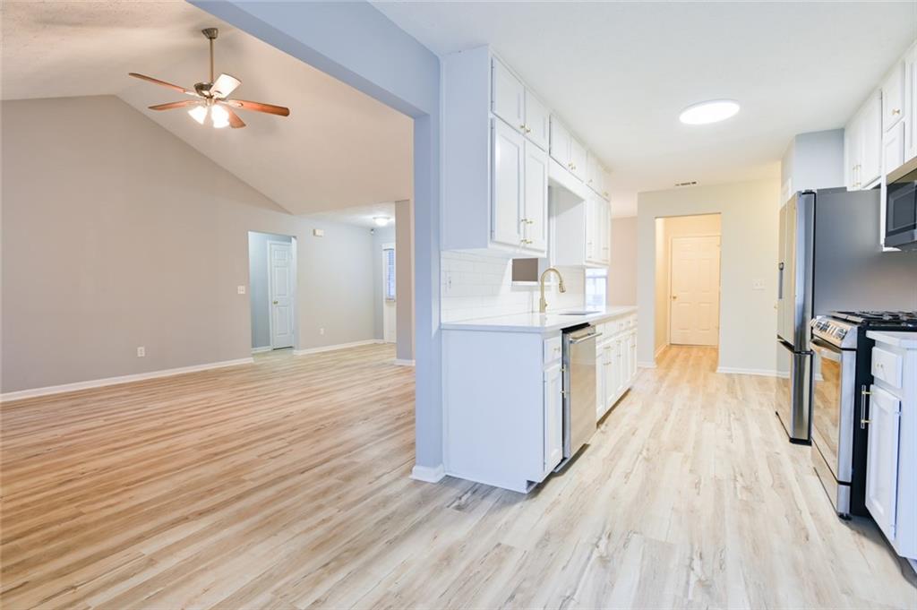 1255 Summit Point Lane Snellville, GA 30078 - Photo 13 of 41 a view of a kitchen from the hallway with a sink