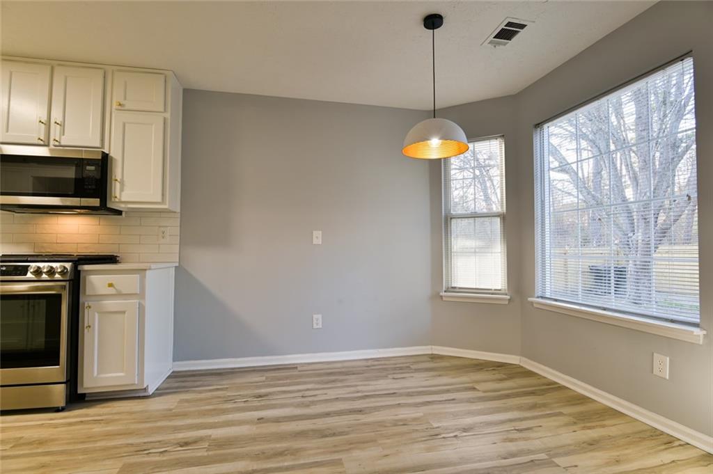 1255 Summit Point Lane Snellville, GA 30078 - Photo 14 of 41 a kitchen with stainless steel appliances granite countertop a stove a sink and a microwave