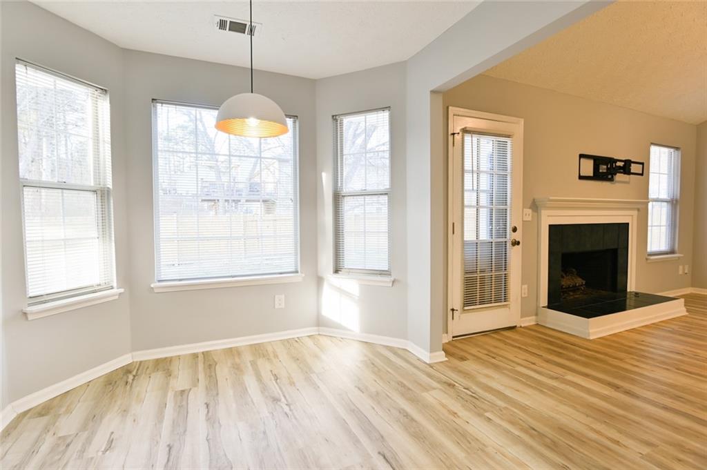 1255 Summit Point Lane Snellville, GA 30078 - Photo 15 of 41 a view of empty room with wooden floor and fireplace