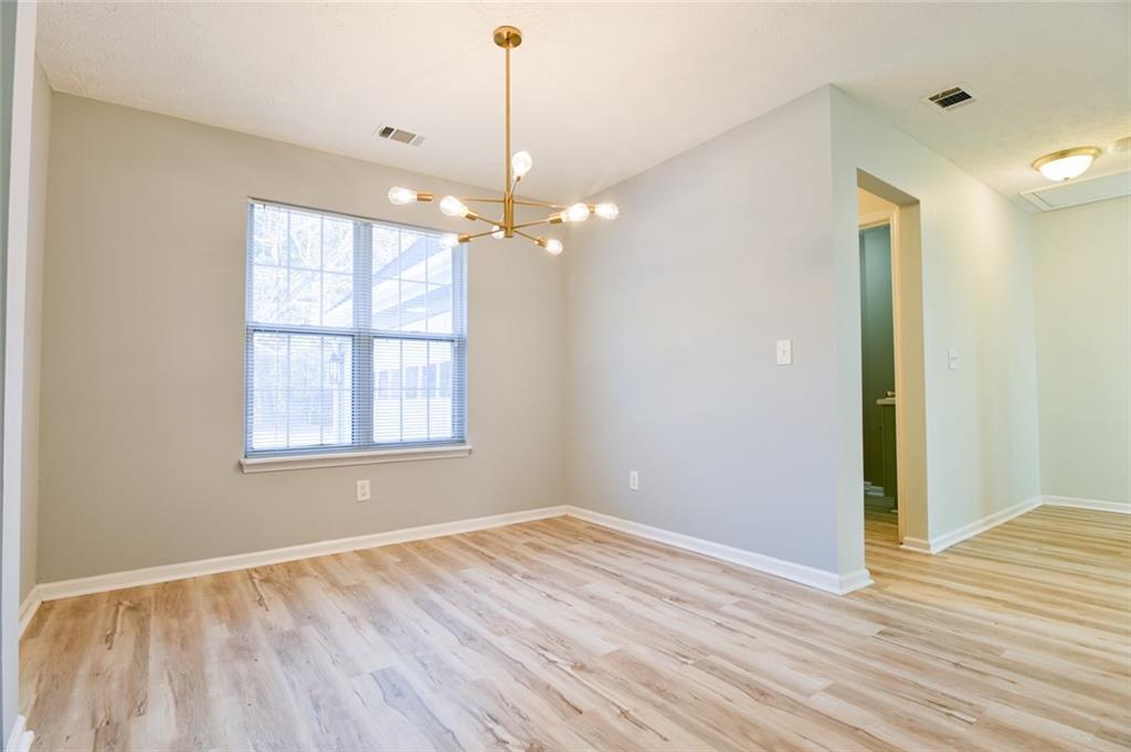 1255 Summit Point Lane Snellville, GA 30078 - Photo 16 of 41 a view of an empty room with wooden floor and a window