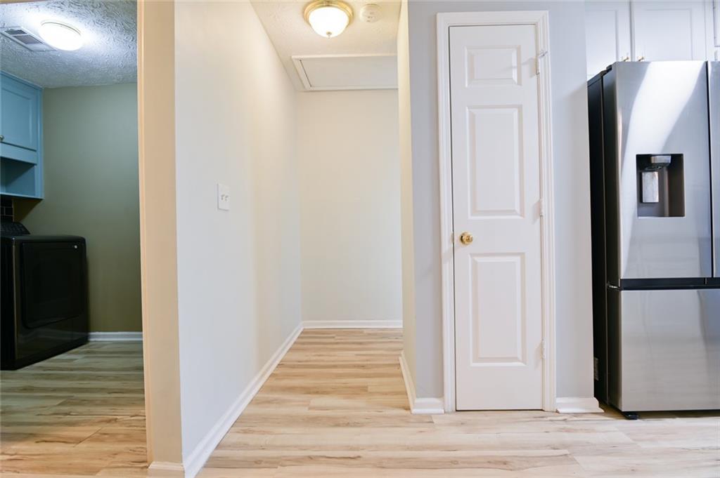 1255 Summit Point Lane Snellville, GA 30078 - Photo 17 of 41 a view of a hallway with wooden floor and staircase