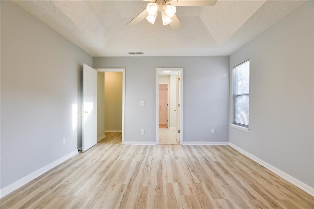 1255 Summit Point Lane Snellville, GA 30078 - Photo 19 of 41 wooden floor in an empty room with a window