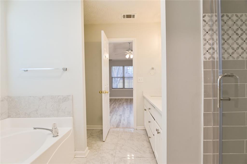 1255 Summit Point Lane Snellville, GA 30078 - Photo 21 of 41 a bathroom with a bathtub and a shower
